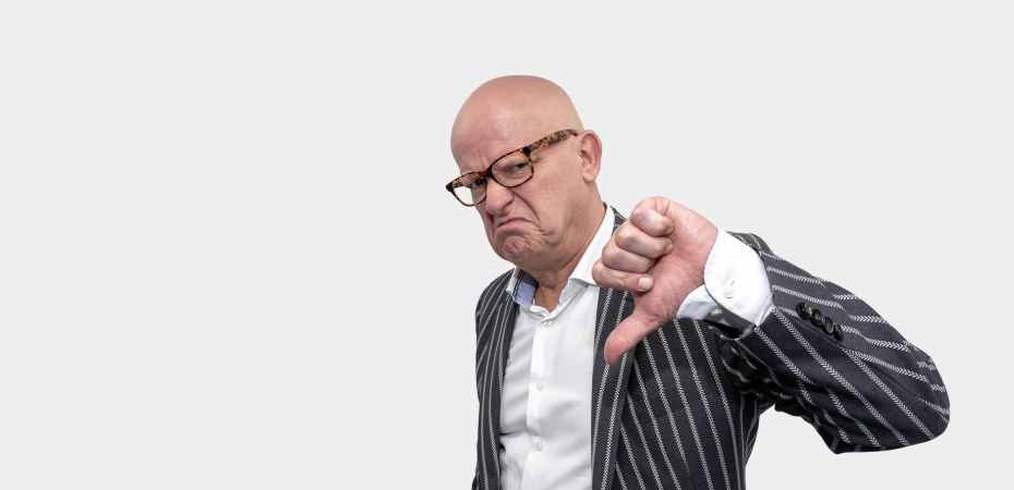 a man flashing the thumbs down sign