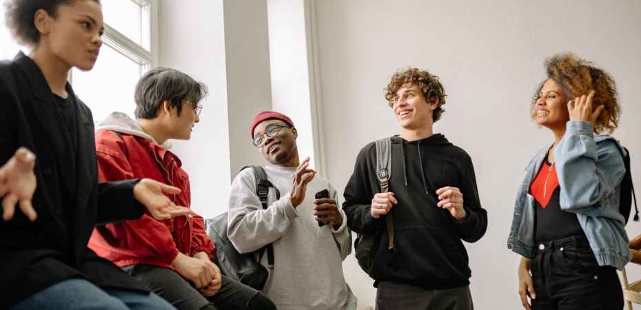 students talking while on a staircase landing
