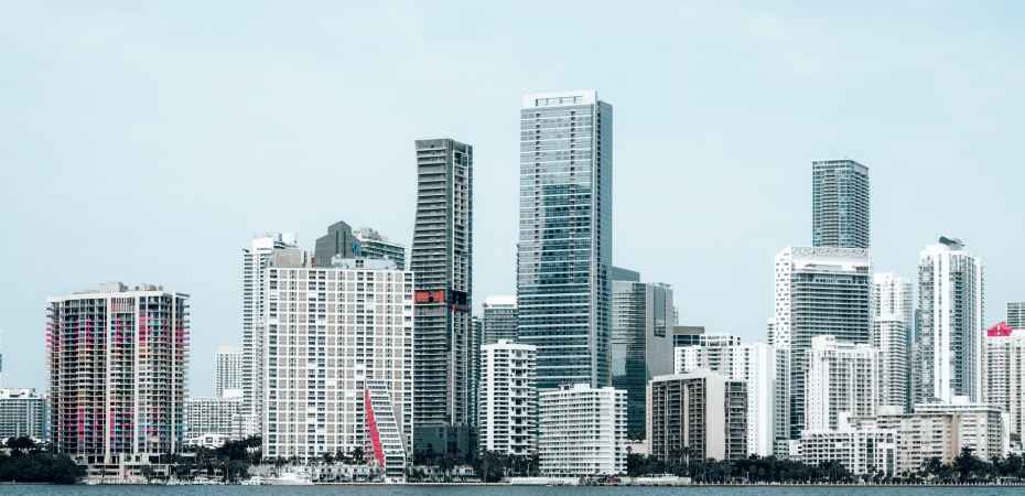 white and gray high rise buildings near body of water